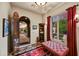 Inviting foyer with decorative rug, bench seating, and an arched doorway leading to an outdoor view at 8139 E Club Village Dr, Gold Canyon, AZ 85118