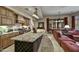 Spacious kitchen with custom cabinets, granite countertops, and a large island with seating and wine rack at 8139 E Club Village Dr, Gold Canyon, AZ 85118