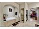 Bright bathroom featuring a garden tub, tile floors, walk-in shower, and seamless access to the main bedroom at 8139 E Club Village Dr, Gold Canyon, AZ 85118