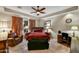 Comfortable main bedroom featuring a ceiling fan, chair, desk, and an abundance of natural light at 8139 E Club Village Dr, Gold Canyon, AZ 85118