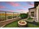 Relaxing backyard with fire pit, chaise lounge, artificial grass and a view of the golf course at 8139 E Club Village Dr, Gold Canyon, AZ 85118