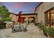 Spacious outdoor patio with dining area, built-in grill, and manicured landscaping at 8139 E Club Village Dr, Gold Canyon, AZ 85118