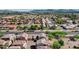 Aerial view of a residential area featuring tiled roofs and tree-lined streets, under a clear blue sky at 8429 W Vernon Ave, Phoenix, AZ 85037