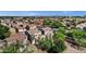 Aerial view showcasing a neighborhood with tree-lined streets, well-manicured lawns, and breathtaking mountain views at 8429 W Vernon Ave, Phoenix, AZ 85037