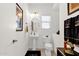 Clean half bathroom featuring a pedestal sink, toilet, and decorative fixtures at 8429 W Vernon Ave, Phoenix, AZ 85037