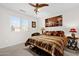 Bedroom featuring a bed with decorative pillows, a table lamp, and a picture hanging above the headboard at 8429 W Vernon Ave, Phoenix, AZ 85037