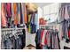 Walk-in closet filled with hanging clothes and storage shelves, offering ample space for organization at 8429 W Vernon Ave, Phoenix, AZ 85037
