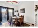 Cozy dining area with a ceiling fan, sliding door to the patio, and wooden table set at 8429 W Vernon Ave, Phoenix, AZ 85037