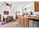 Kitchen featuring wood cabinets, a stainless steel sink, and an open view to the dining and living areas at 8429 W Vernon Ave, Phoenix, AZ 85037