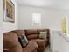 Comfortable loft area featuring a plush sofa, accent pillows, and natural light at 8429 W Vernon Ave, Phoenix, AZ 85037