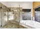 Elegant bathroom with a glass-enclosed shower, soaking tub, and neutral tile finishes at 9 E Los Arboles Cir, Tempe, AZ 85284