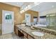 Bright bathroom with dual sinks, granite countertops, a large mirror, and natural lighting at 9 E Los Arboles Cir, Tempe, AZ 85284