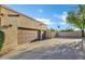 Spacious attached garage with multiple doors and a wide driveway, offering ample parking at 9 E Los Arboles Cir, Tempe, AZ 85284