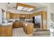 Traditional kitchen featuring wood cabinetry, stainless steel appliances, and a central island at 9 E Los Arboles Cir, Tempe, AZ 85284