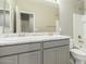 Bathroom featuring a dual sink vanity with light gray cabinets and a tub shower at 9822 W Caron Dr, Peoria, AZ 85345