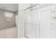 Bright bathroom featuring a glass-enclosed shower with built-in shelving, and neutral wall colors at 9822 W Caron Dr, Peoria, AZ 85345