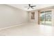 Bright bedroom with sliding glass door and modern ceiling fan, lots of natural light at 9822 W Caron Dr, Peoria, AZ 85345