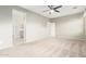 Primary bedroom with ensuite bathroom featuring carpeted floors and a ceiling fan at 9822 W Caron Dr, Peoria, AZ 85345