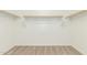 Walk-in closet offering ample storage space with neutral carpet and white walls at 9822 W Caron Dr, Peoria, AZ 85345
