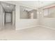 Open-concept dining room area featuring tile flooring, a chandelier, and a view of the living room at 9822 W Caron Dr, Peoria, AZ 85345