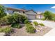Beautiful home exterior with a two-car garage and low-maintenance desert landscaping at 9822 W Caron Dr, Peoria, AZ 85345