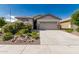 Inviting single-Gathering home with a spacious driveway, two-car garage and beautiful desert landscaping at 9822 W Caron Dr, Peoria, AZ 85345