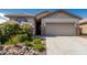 Charming single-Gathering home featuring a two-car garage and low-maintenance desert landscaping at 9822 W Caron Dr, Peoria, AZ 85345