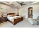 This elegant bedroom features a coffered ceiling, a ceiling fan, and large windows at 10511 E Skinner Dr, Scottsdale, AZ 85262