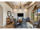 Elegant dining room featuring a stylish chandelier, coffered ceiling, and plenty of natural light at 10511 E Skinner Dr, Scottsdale, AZ 85262