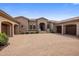Luxury home exterior with a spacious driveway, well-manicured landscaping, and multiple garages at 10511 E Skinner Dr, Scottsdale, AZ 85262