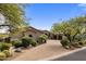 Attractive home exterior with a paver driveway, desert landscaping, and a three-car garage at 10511 E Skinner Dr, Scottsdale, AZ 85262