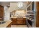 Gourmet kitchen with custom cabinetry, tile backsplash, stainless steel appliances, and granite counters at 10511 E Skinner Dr, Scottsdale, AZ 85262