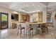 Spacious kitchen featuring a large island with seating, granite countertops, and custom cabinetry at 10511 E Skinner Dr, Scottsdale, AZ 85262