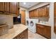 Well-equipped laundry room with custom cabinetry, a sink, and modern washer and dryer at 10511 E Skinner Dr, Scottsdale, AZ 85262