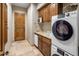 Well-equipped laundry room boasts ample cabinetry, washer, dryer and convenient sink at 10511 E Skinner Dr, Scottsdale, AZ 85262