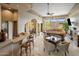 Spacious living room with a wet bar, stone columns, fireplace, and ample seating for entertaining at 10511 E Skinner Dr, Scottsdale, AZ 85262