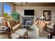 Inviting living room with a cozy fireplace, plush seating, and large windows with beautiful views at 10511 E Skinner Dr, Scottsdale, AZ 85262