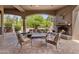 Comfortable outdoor living space with fireplace and views of desert landscaping at 10511 E Skinner Dr, Scottsdale, AZ 85262