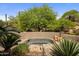 Relaxing in-ground spa surrounded by lush desert landscaping and mature trees at 10511 E Skinner Dr, Scottsdale, AZ 85262