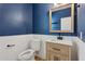 Stylish half bath featuring wainscotting, modern vanity and elegant fixtures at 11142 E Ravenna Ave, Mesa, AZ 85212