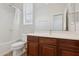 Bathroom featuring a bathtub with shower and a vanity with dark wood cabinets and sink at 11142 E Ravenna Ave, Mesa, AZ 85212