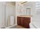 Bathroom featuring glass enclosed shower and a vanity with dark wood cabinets and sink at 11142 E Ravenna Ave, Mesa, AZ 85212