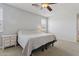 Bright Primary bedroom featuring a ceiling fan and a large window at 11142 E Ravenna Ave, Mesa, AZ 85212