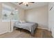 Neutral bedroom with wood look floors and a large window letting in natural light at 11142 E Ravenna Ave, Mesa, AZ 85212