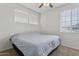 Bedroom featuring carpeted floor, ceiling fan, and large windows at 11142 E Ravenna Ave, Mesa, AZ 85212