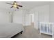 Spacious bedroom with ceiling fan, carpeted floors, and adjacent to a Bedroom at 11142 E Ravenna Ave, Mesa, AZ 85212
