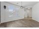 Light-filled room features wood-style floors and large windows at 11142 E Ravenna Ave, Mesa, AZ 85212