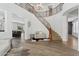 Spacious living room with elegant staircase, hardwood floors, and an open view to the dining area at 11142 E Ravenna Ave, Mesa, AZ 85212