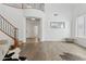 Bright and open living area with wood flooring and staircase, perfect for entertaining guests at 11142 E Ravenna Ave, Mesa, AZ 85212