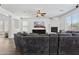 Comfortable living room features a large gray sectional sofa, brick fireplace, and ample natural light from large windows at 11142 E Ravenna Ave, Mesa, AZ 85212